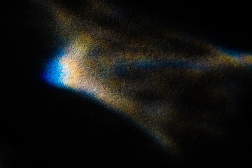 abstract light glow, lens flare, caustics water glas reflections.  light through a prism. black...