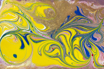 Yellow and gold marbling pattern. Golden marble liquid texture.