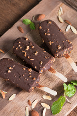 Ice cream covered with chocolate and almonds sticks. Top view.