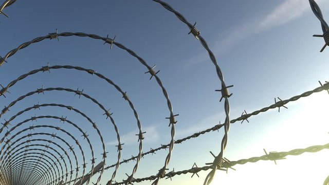 FPV camera moving inside barbed wire spiral fence, seamless loop