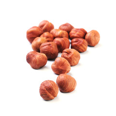 Hazelnuts isolated on white background. Selective focus.