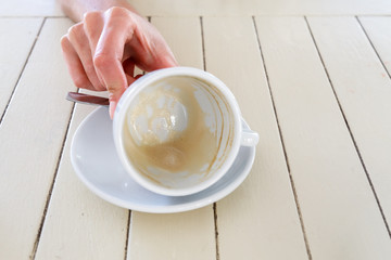 Empty cup of cappuccino and milk foam