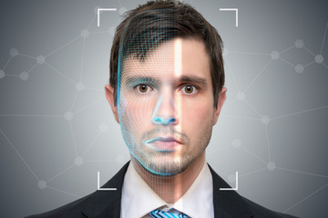 Biometric scanner is scanning face of young man. Detection and recognition concept.