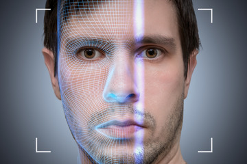 Biometric scanner is scanning face of young man. Artificial intelligence concept.