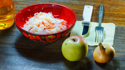 A wonderful snack is salted shredded cabbage with carrots. It is also necessary to cut the onion, a little apple and add sunflower oil