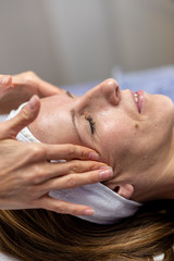 Young woman enjoying a rejuvenating face massage