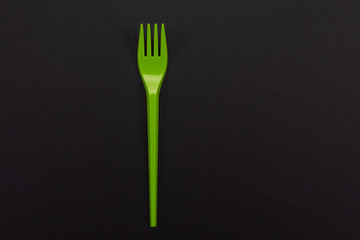 Top-view of disposable green plastic fork isolated on background