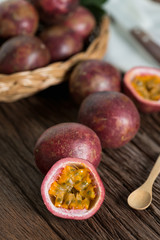 Half of  passion fruit and organic passionfruit on wood basket, wooden background.