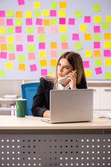 Young beautiful businesslady in conflicting priorities concept 