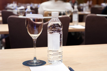 Water, glass and notebook on the table