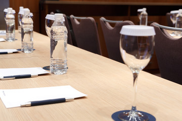 Water, glass and notebook on the table