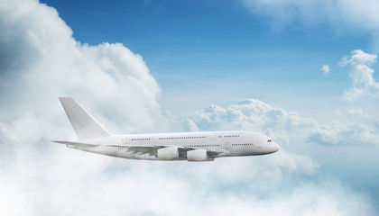 Huge two-storey passengers commercial airplane flying above dramatic clouds. Travel and business concept.