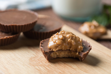 Homemade peanut butter cup, dark chocolate with milk bottle, dessert food.