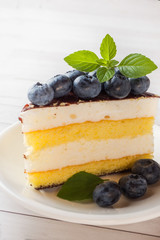 Cake of a souffle with glaze and fresh blueberries.