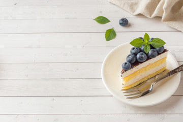 Cake of a souffle with glaze and fresh blueberries. copy space
