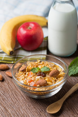 Healthy breakfast concept. Oat flakes with Muesli and almond, fruit, milk bottle.