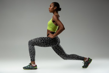 Fototapeta na wymiar Profile photo of cute sportswoman that stretching legs