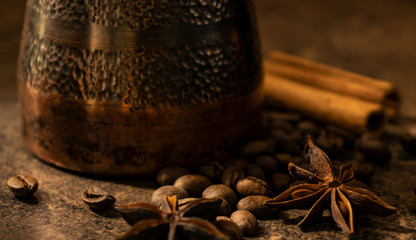 Copper Turk, coffee beans, cinnamon and star anise close-up.