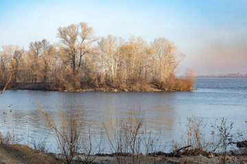 Early morning with trees reflection on the Dnieper river in winter. Kiev, Ukraine