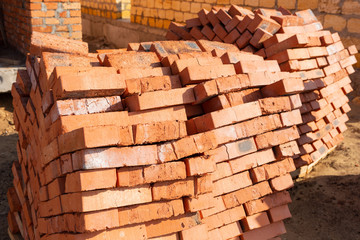 red brick laid out on a pallet, a lot of bricks on the construction site