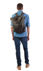 Fototapeta premium Back view of a man with a green bag.