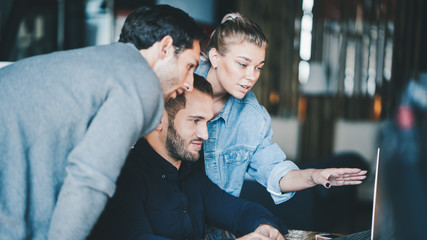 Business teamwork situation. Group of three people discussing daily flow in the office