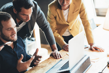Business teamwork situation. Group of three people discussing daily tasks in the office