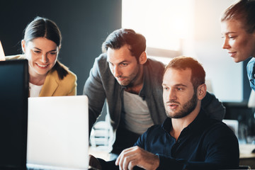 Business teamwork situation. Group of four people discussing daily tasks in the office