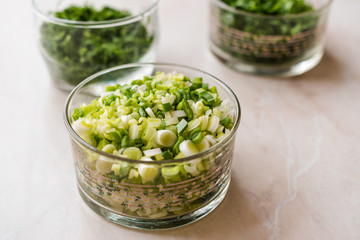 Chopped Chives, Parsley and Dill in Glass Bowls.