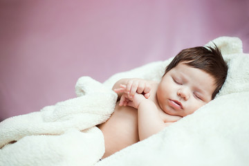 Obraz na płótnie Canvas baby, newborn baby cute blue-eyed, dark hair, baby 2 months without clothes sleeps