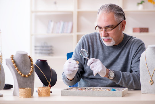 White bearded old jeweler at workshop