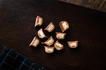 Tahini Filled Chocolate Pieces on Dark Wooden Surface / Tahin.