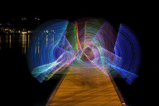 abstract background with light painting on a pier at a lake in varese (italy)
