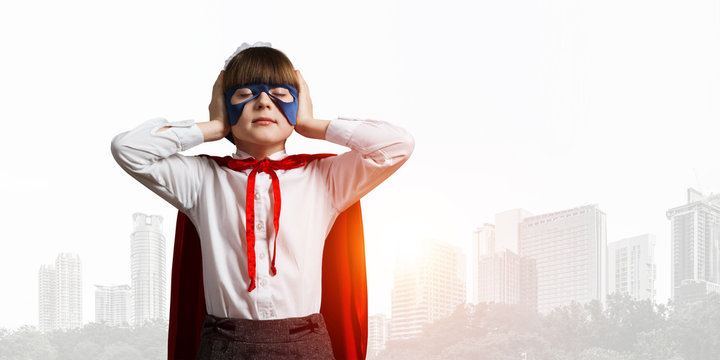 Kid girl superhero against cityscape background annoyed by city sounds