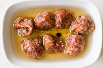 Marinated Canned Anchovy Fillet in Bowl / Anchovies served with Black Pepper on Marble Board.