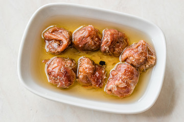 Marinated Canned Anchovy Fillet in Bowl / Anchovies served with Black Pepper on Marble Board.