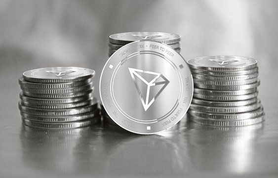 Tronix (TRX) digital crypto currency. Stack of silver coins. Cyber money.