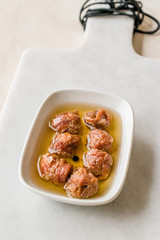 Marinated Canned Anchovy Fillet in Bowl / Anchovies served with Black Pepper on Marble Board.