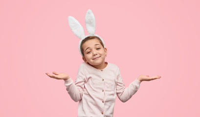 Girl with bunny ears shrugging shoulders