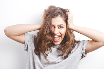 Shocked smiling girl on a white background. 