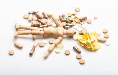 Immunity and medicine vitamins. Overdose and death. Medicine prescription. Wooden human dummy lay on pile of pills and tablets. Take medicine concept. Health and treatment. Health care and problems