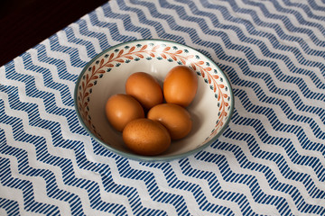 bowl of eggs, five brown eggs in a bowl