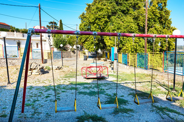 Fototapeta premium Old empty playground in Greek village on Island of Rhodes (Rhodes, Greece)