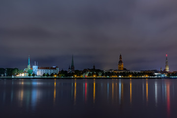 Panoramic night view on old Riga the capital of Latvia city from left bank of Daugava river. Its unique with a medieval and Gothic architecture.