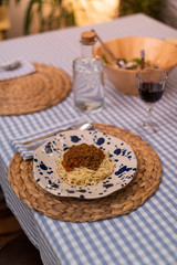 spaghetti bolognese served with wine