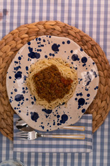 spaghetti bolognese served with wine