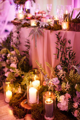 A lot of decorations are standing near the table with a bunch of cutlery and decorations on it.