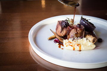 Pouring gravy on roast beef