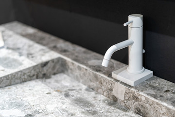 Closed tap over the sink in new bathroom