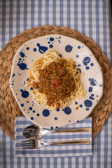 spaghetti bolognese served with wine